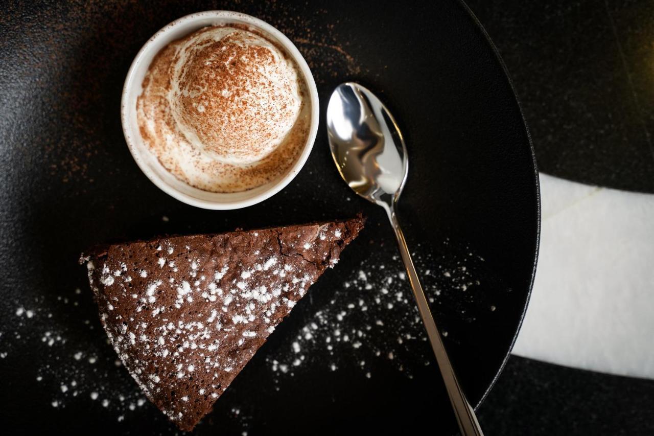 Ambiance Boutique Art Hotel Lahore Extérieur photo A chocolate cake with a cup of coffee